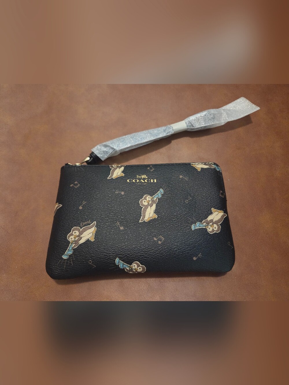 Coach Black Leather Wristlet with Penguin Motif and Gold Logo